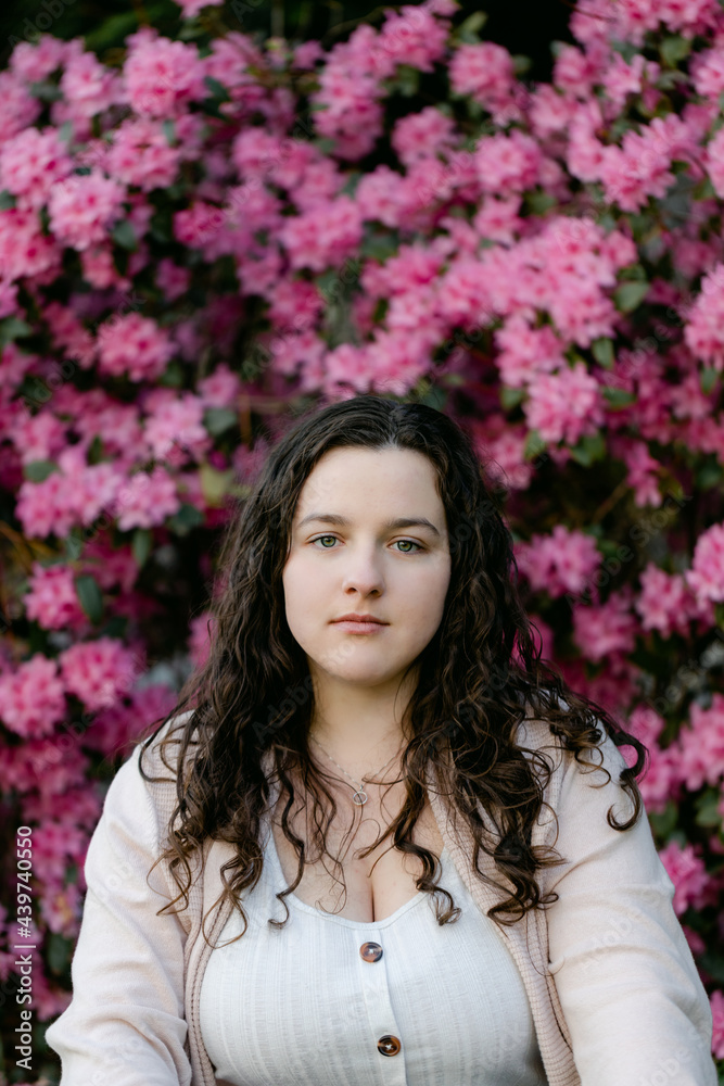 Brunette Teenager in front of Flowers