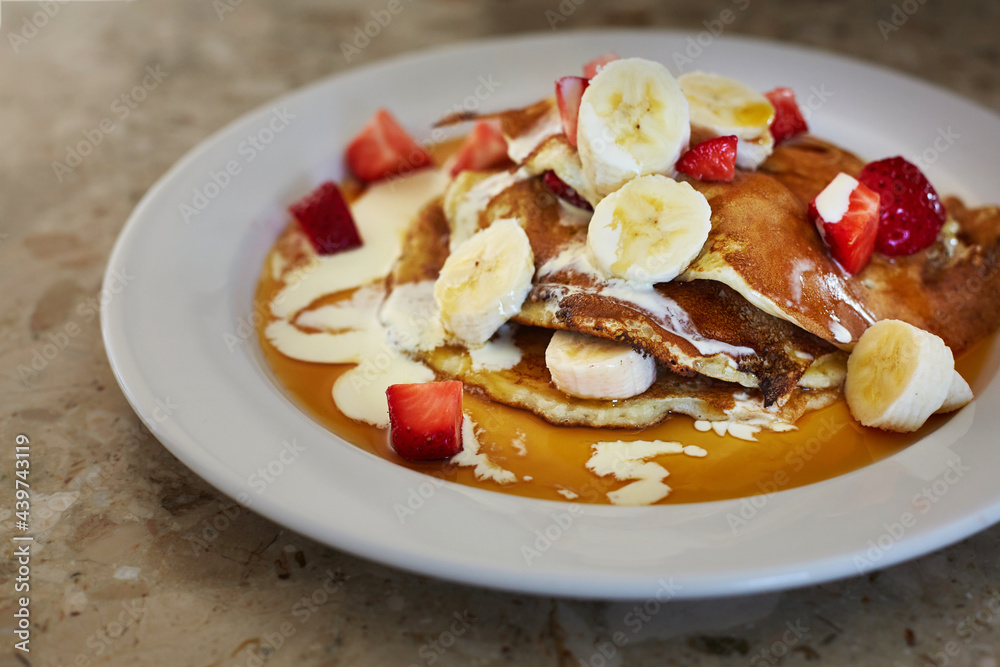 Breakfast pancakes with strawberries, bananas and cream Breakfast pancakes with strawberries, bananas and cream