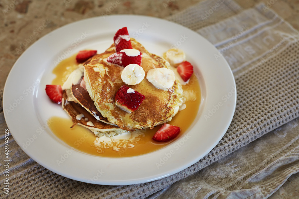 Breakfast pancakes with strawberries, bananas and cream Breakfast pancakes with strawberries, bananas and cream