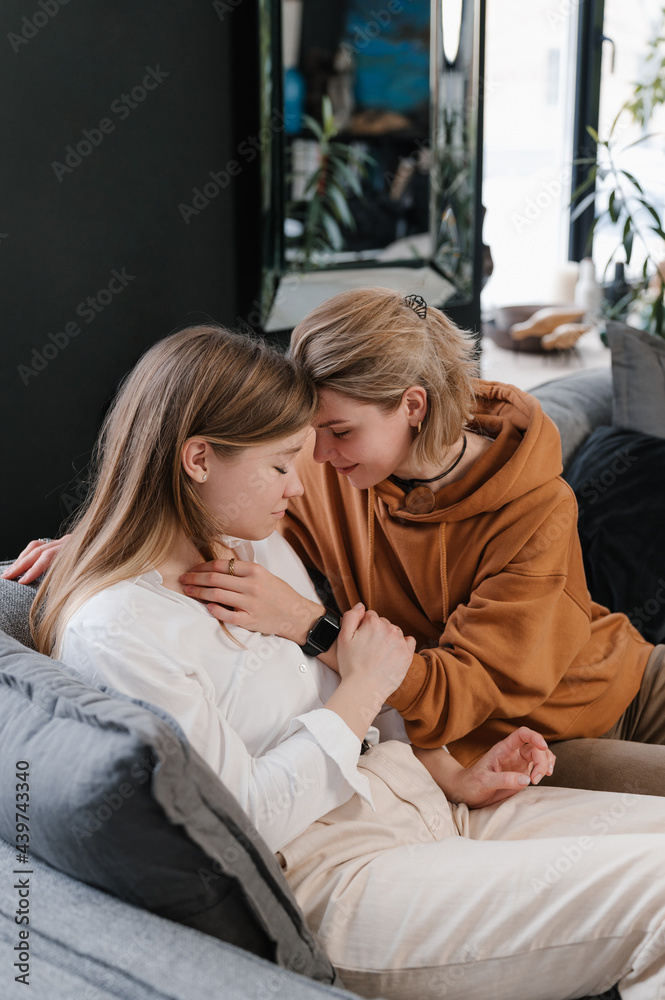 Happy lesbian couple embracing during psychotherapy appointment Happy lesbian couple embracing during psychotherapy appointment