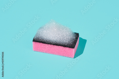 pink kitchen sponge with soap foam photo