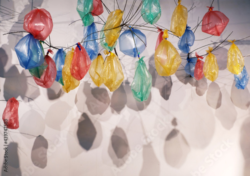 Colorful plastic bags tied to the branches to make a decorative background. Indoor activities