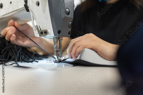 Young woman working with sewing machine photo