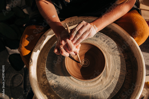 Female hands working on a pottery wheel