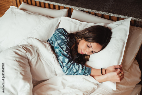 Young woman sleeping in cozy bed