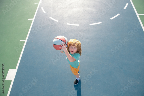 Kids playing basketball, outdoor on playground. Child sport activity. Kid sports man. © Volodymyr