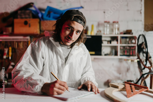 Young man working at his workshop photo