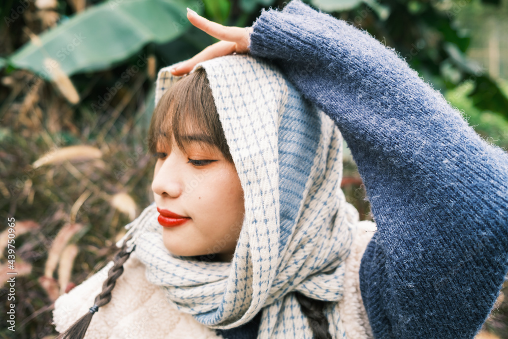 © Pansfun Images/Stocksy - Portrait of young fashionable Asian woman with two braids © Pansfun Images/Stocksy - Portrait of young fashionable Asian woman with two braids