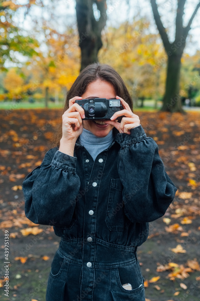 Woman taking Pictures of Autumn with an Old Camera Woman taking Pictures of Autumn with an Old Camera