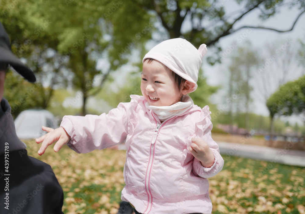 Two year old babygirl playing in the park with father,Shanghai,Asia Two year old babygirl playing in the park with father,Shanghai,Asia