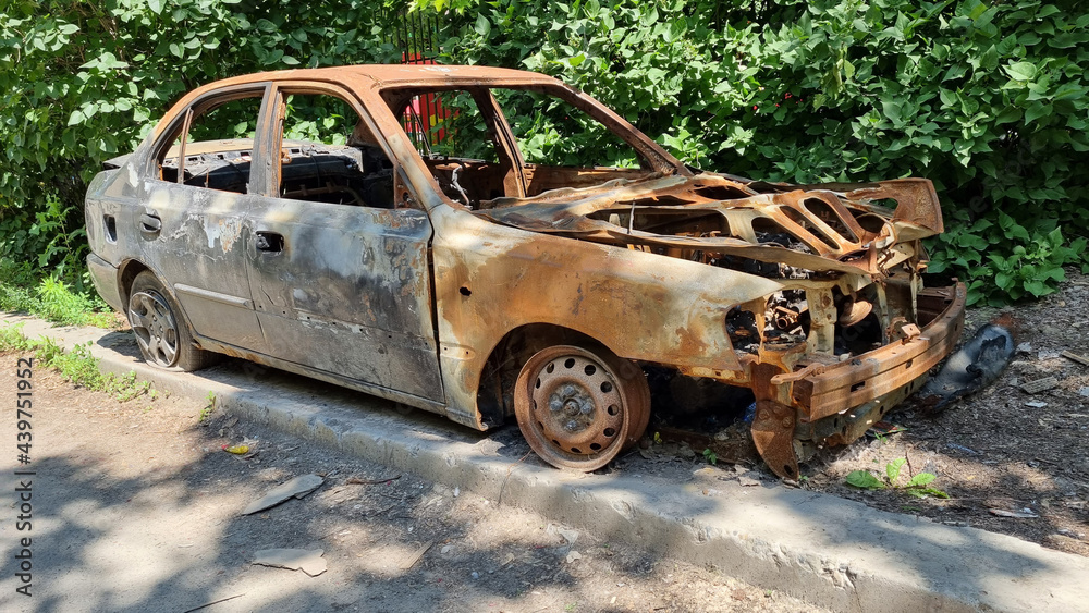 a car stands on the side after a fire. vandalism and damage to property. a car stands on the side after a fire. vandalism and damage to property.