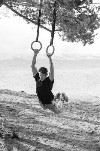 Male athlete Doing Pull Ups On Rings
 photo