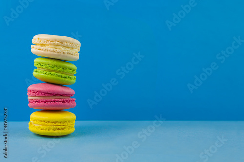 Multicolored macaroons on a blue background,