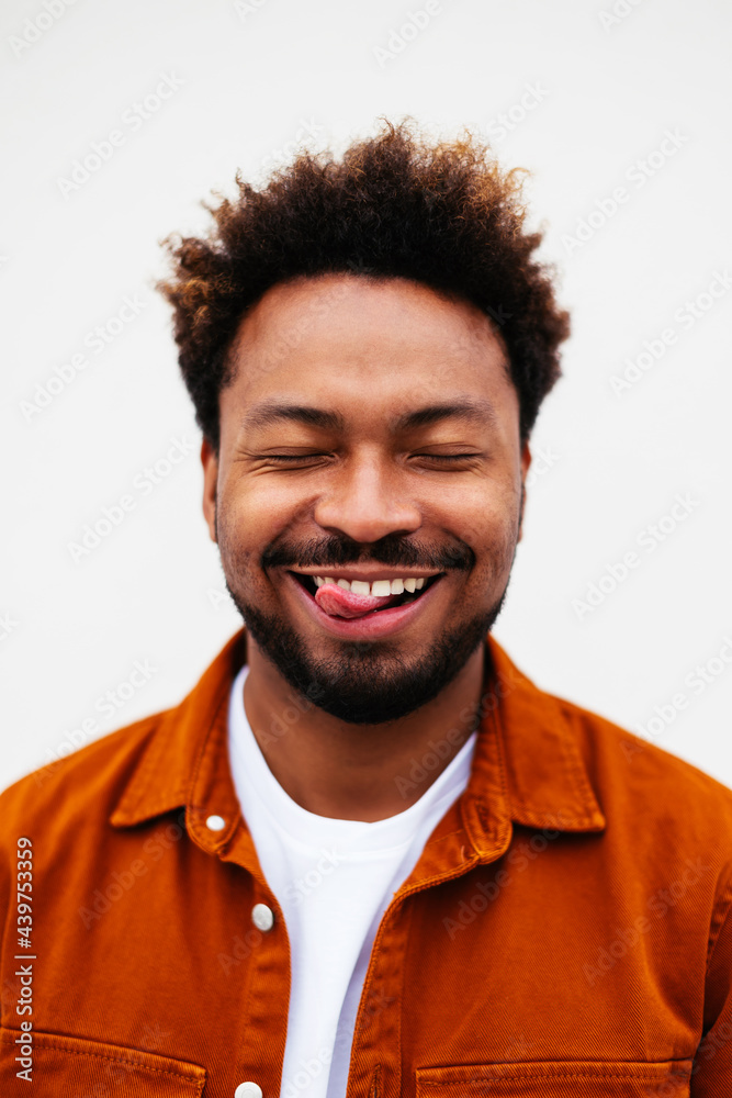 Happy black man showing tongue on white background Happy black man showing tongue on white background