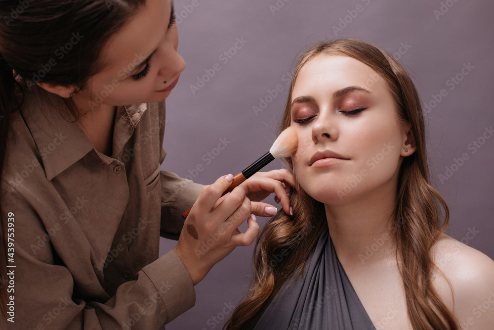 Make up artist working with model Make up artist working with model