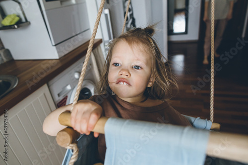 Child in hanging swing photo