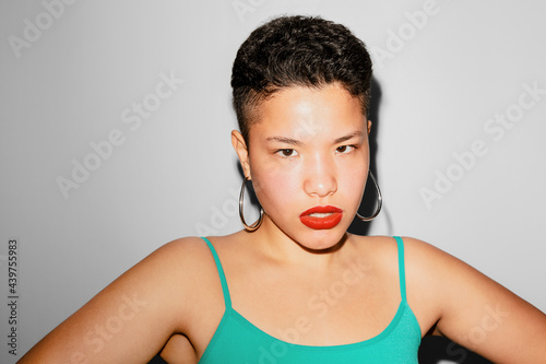 Portrait of young woman with angry look photo