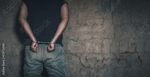 Tableau sur toile Handcuffed hand of a prisoner in prison, dangerous criminal punished by law