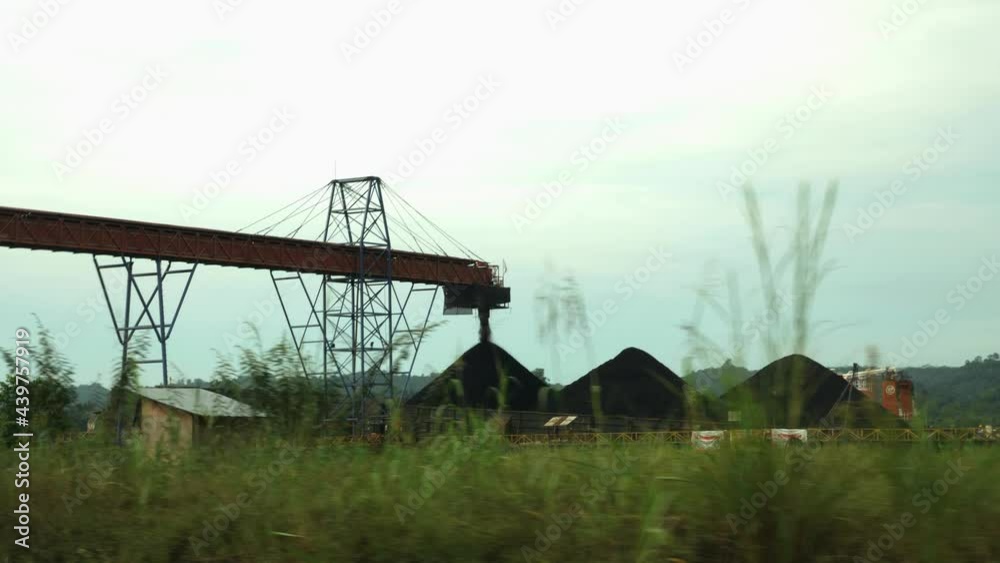 Coal loading equipment conveyor filling a ship with coal Coal loading equipment conveyor filling a ship with coal