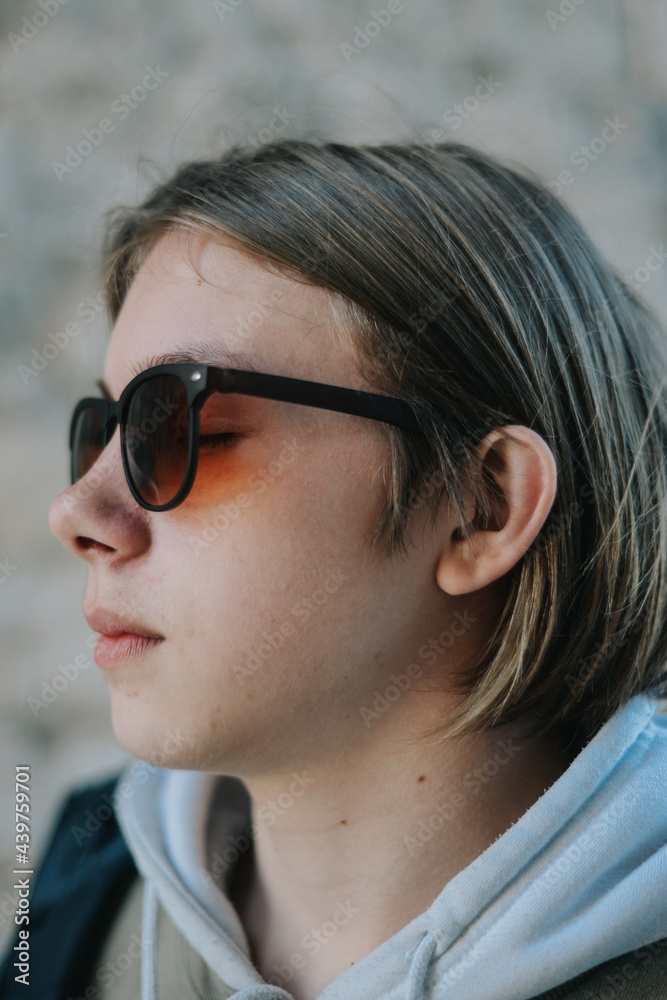 A blond teenager with sunglasses A blond teenager with sunglasses