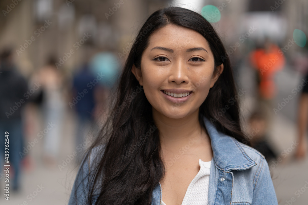 Fototapeta premium Young Asian woman in city smile happy face portrait