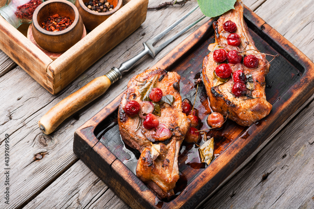 Grilled pork steaks with cherry sauce