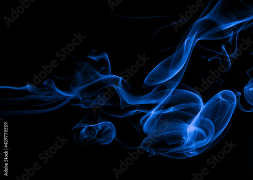Blue smoke movement abstract on black background, darkness concept