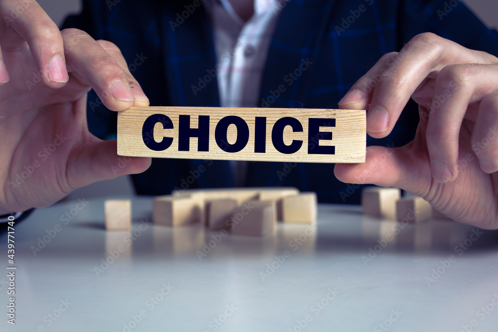 Businessman hand holding wooden cube block with CHOICE business word on table background. Mission, Vision and core values concept Businessman hand holding wooden cube block with CHOICE business word on table background. Mission, Vision and core values concept