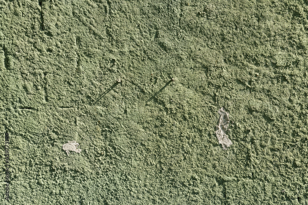 Green wall texture with reliefs. Closeup. Green background. Green wall texture with reliefs. Closeup. Green background.