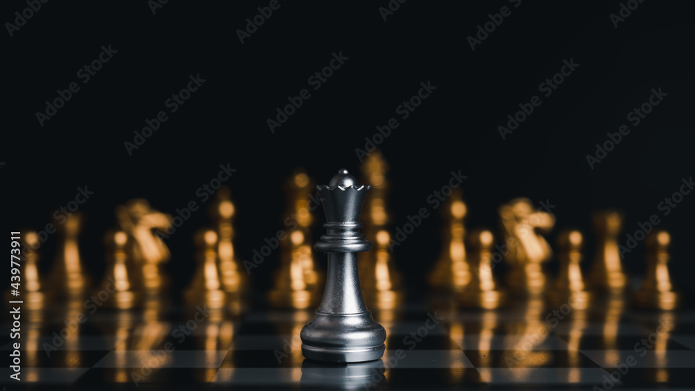 The silver king chess stood in front of the golden chess. Demonstrates leadership in strategic thinking and business victories.on black background. The silver king chess stood in front of the golden chess. Demonstrates leadership in strategic thinking and business victories.on black background.