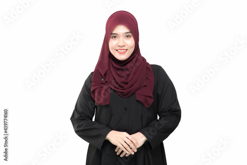 A beautiful Asian Muslim woman is smiling, on isolate white background, with copy space.