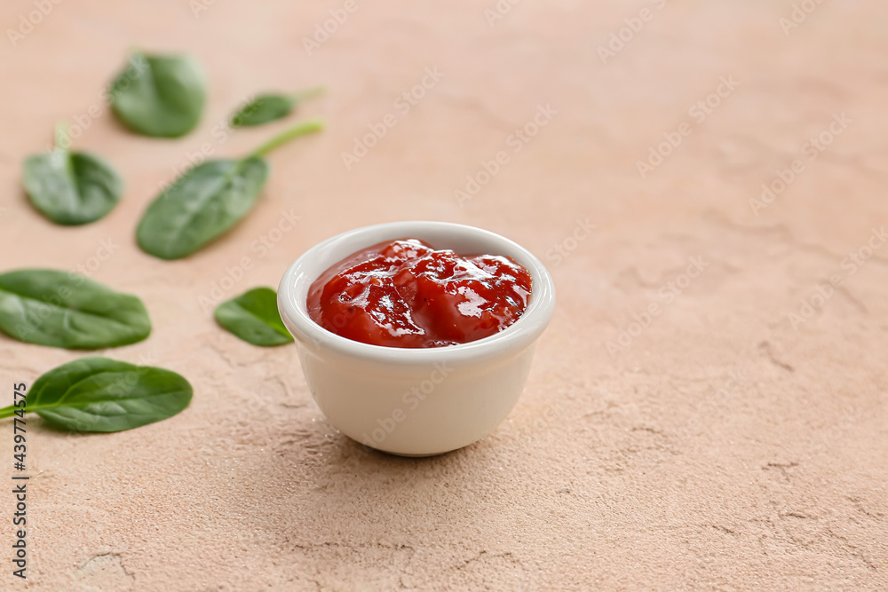 Bowl with tasty barbecue sauce on color background Bowl with tasty barbecue sauce on color background