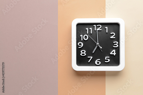 Stylish clock on color background