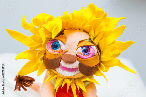Handmade doll in the form of a sunflower, close-up. Handmade doll in the shape of a sunflower. Vintage funny doll. Sunflower doll.