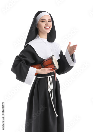 Young nun with drum on whit...