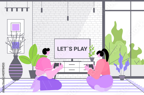 couple having fun playing video games man woman using wireless gamepads game e-sports leisure gaming industry