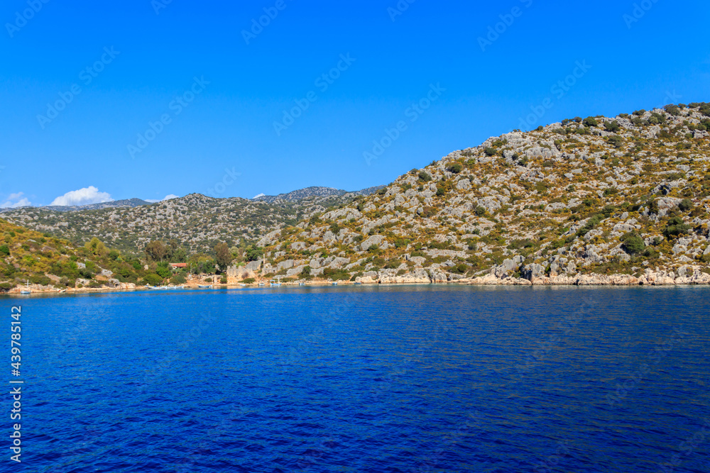 Boats moored at rocky shore of the Mediterranean Sea near Simena in Antalya province, Turkey