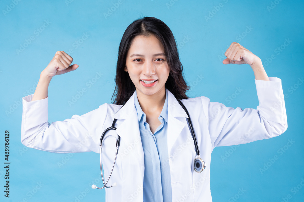 portrait of young female doctor, isolated on blue background portrait of young female doctor, isolated on blue background