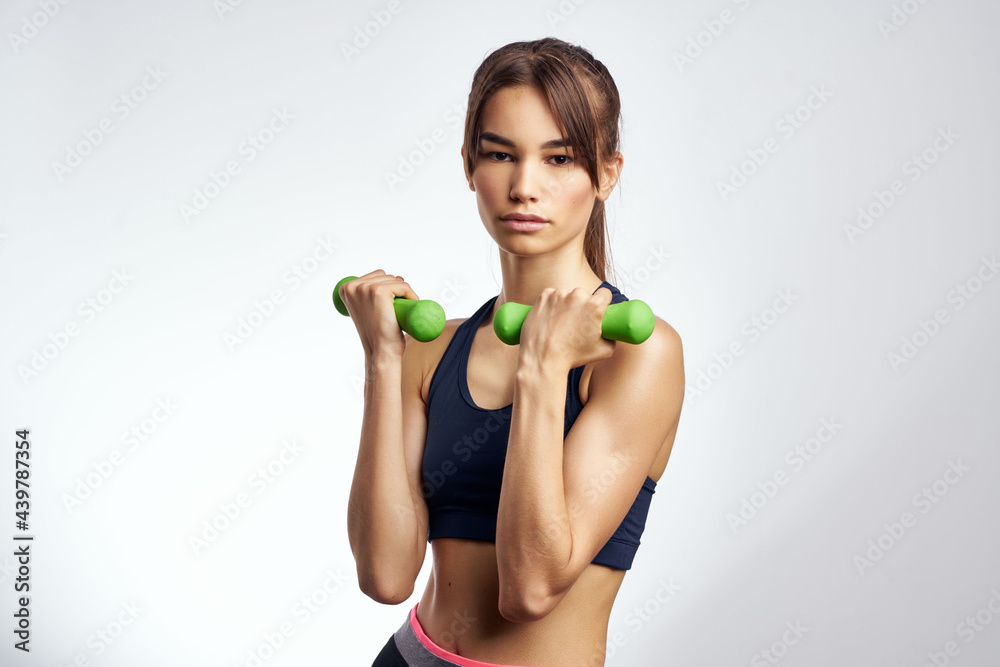 pretty athletic woman with dumbbells in hands pumping up muscles fitness pretty athletic woman with dumbbells in hands pumping up muscles fitness