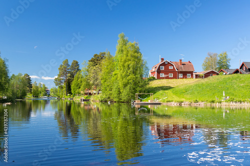 house on a river bank in the Swedish countryside photo