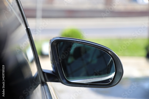 Rearview mirror on a modern car. Car side mirror. © Toghrul