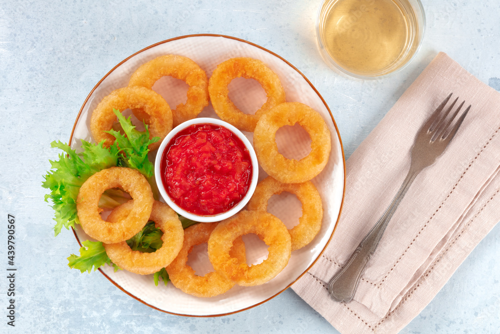 Calamari rings. Deep fried squid rings with salad, ketchup, and wine, top shot Calamari rings. Deep fried squid rings with salad, ketchup, and wine, top shot
