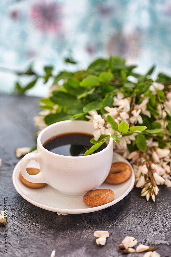 Cup of coffeel and acacia closeup. Nutrition. background with a cup of Coffee and acacia flowers. Cup of coffeel and acacia closeup. Nutrition. background with a cup of Coffee and acacia flowers.