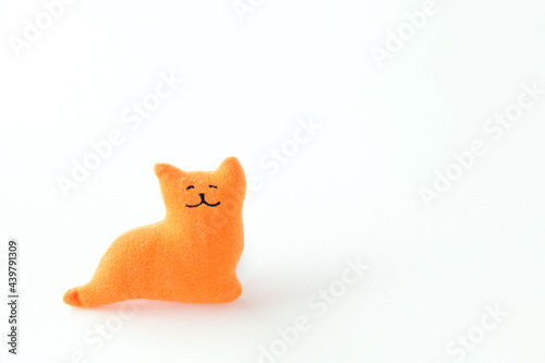 little orange cat lying in the bed.