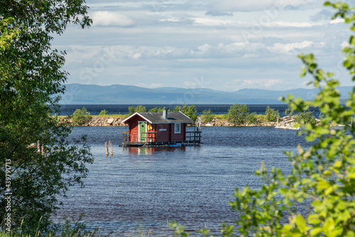 small cabin floating on a lake in the Swedish countryside photo