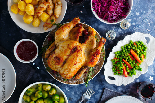 Festive dinner with chicken, brussels sprouts, peas, carrots, red cabbage salad, top view, selective focus
