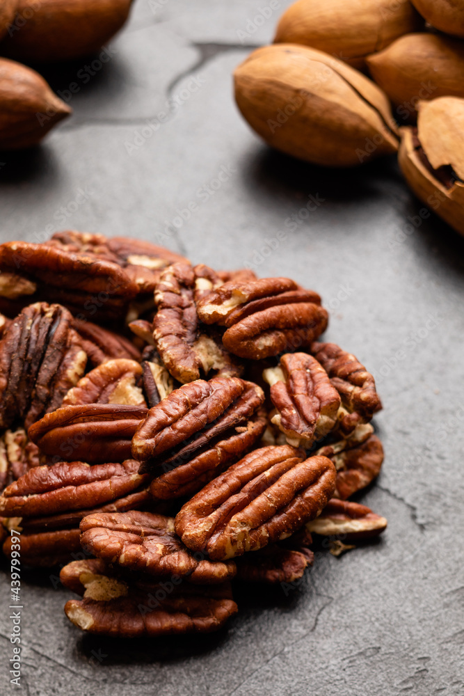 Close up heap of pecan on the black table Close up heap of pecan on the black table