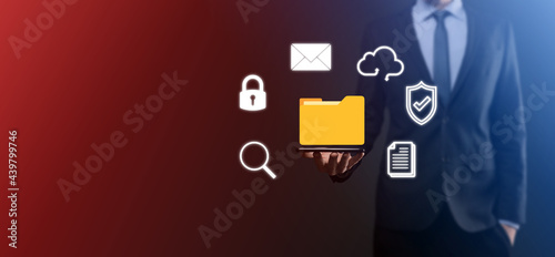 Document Management System DMS .Businessman hold folder and document icon.Software for archiving, searching and managing corporate files and information.Internet Technology Concept.Digital security photo