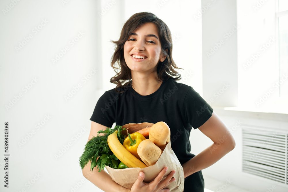 woman with a package of groceries healthy food cooking shopping woman with a package of groceries healthy food cooking shopping