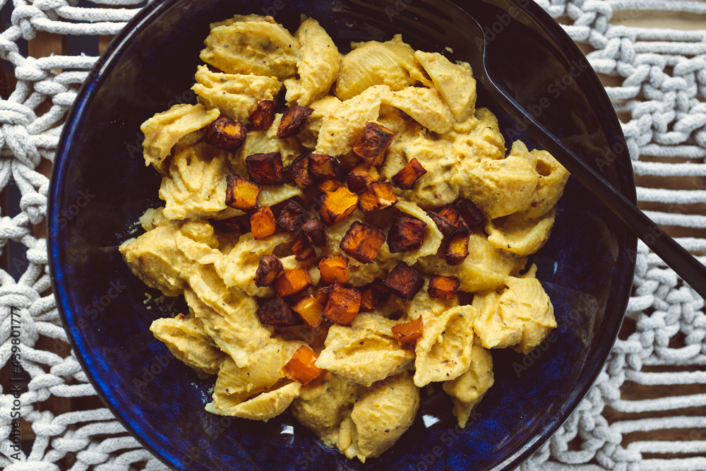 vegan creamy pumpkin pasta with roasted pumpkin cubes as topping, healthy plant-based food vegan creamy pumpkin pasta with roasted pumpkin cubes as topping, healthy plant-based food